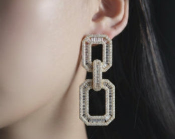 Close-up of a diamond earring on an ear 